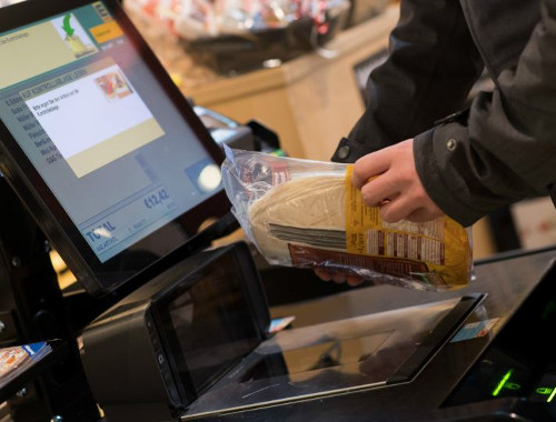 person scanning items at the grocery store