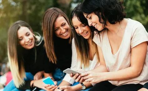 Women enjoying Facebook on a nice day